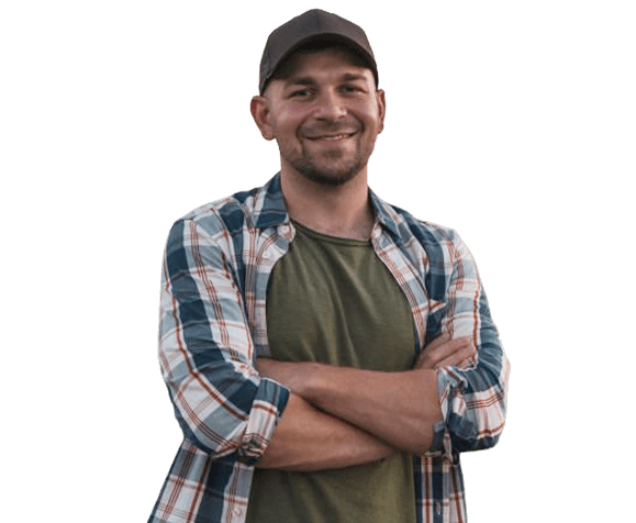 A man in a flannel shirt, smiling to camera