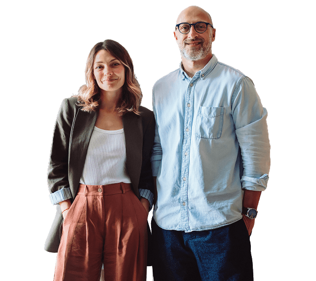 A man and woman standing together, smiling to camera