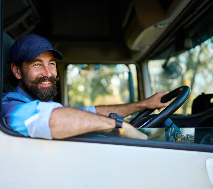 A truck driver smiling to camera
