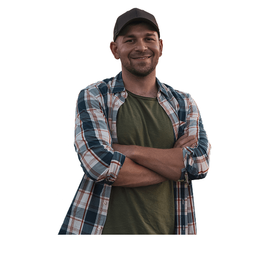 A man in a flannel shirt, smiling to camera