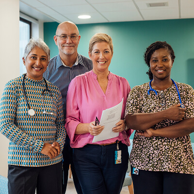 A group of medical professionals smiling to camera
