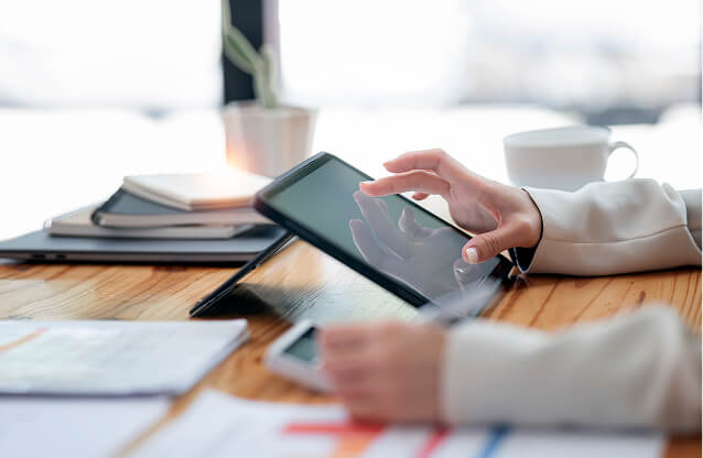 A hand interacting with a tablet device