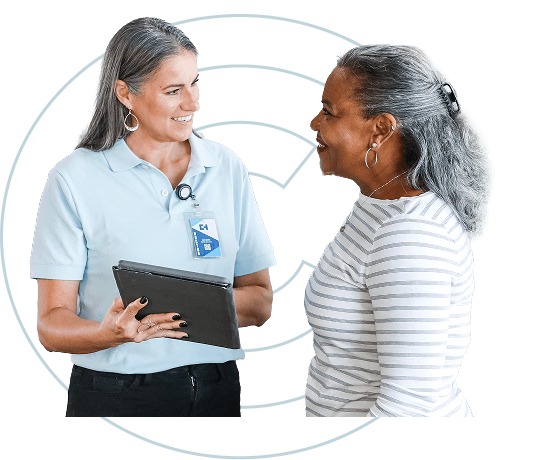 A health professional and a patient smiling at each other