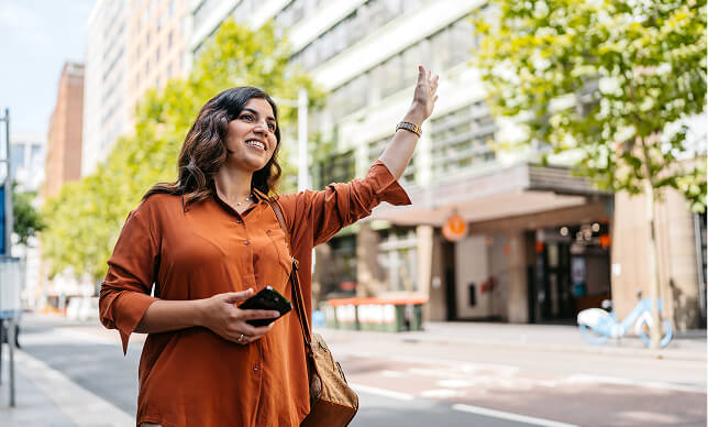 A woman hailing a taxi
